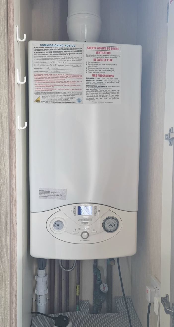Older LPG boiler before replacement in a static caravan